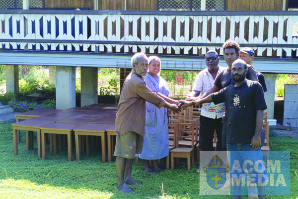 Br. Samson and Sister Neslyn receiving the chairs and tables from the builders